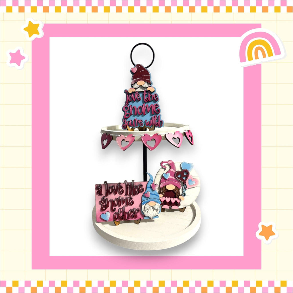 a three tiered cake on a stand with a rainbow in the background