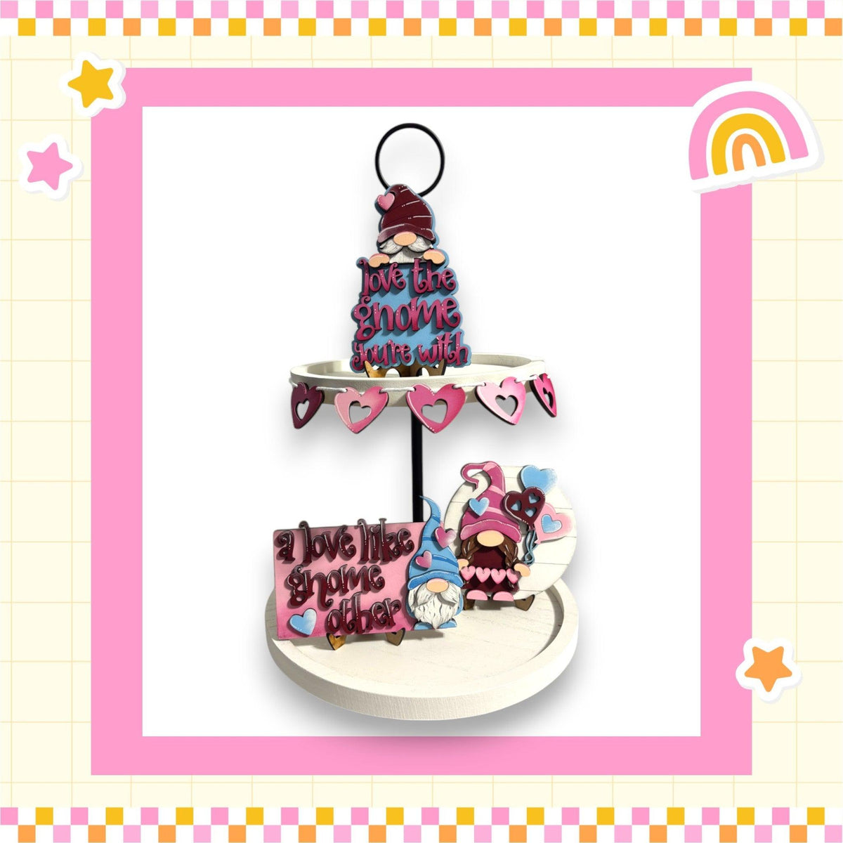 a three tiered cake on a stand with a rainbow in the background