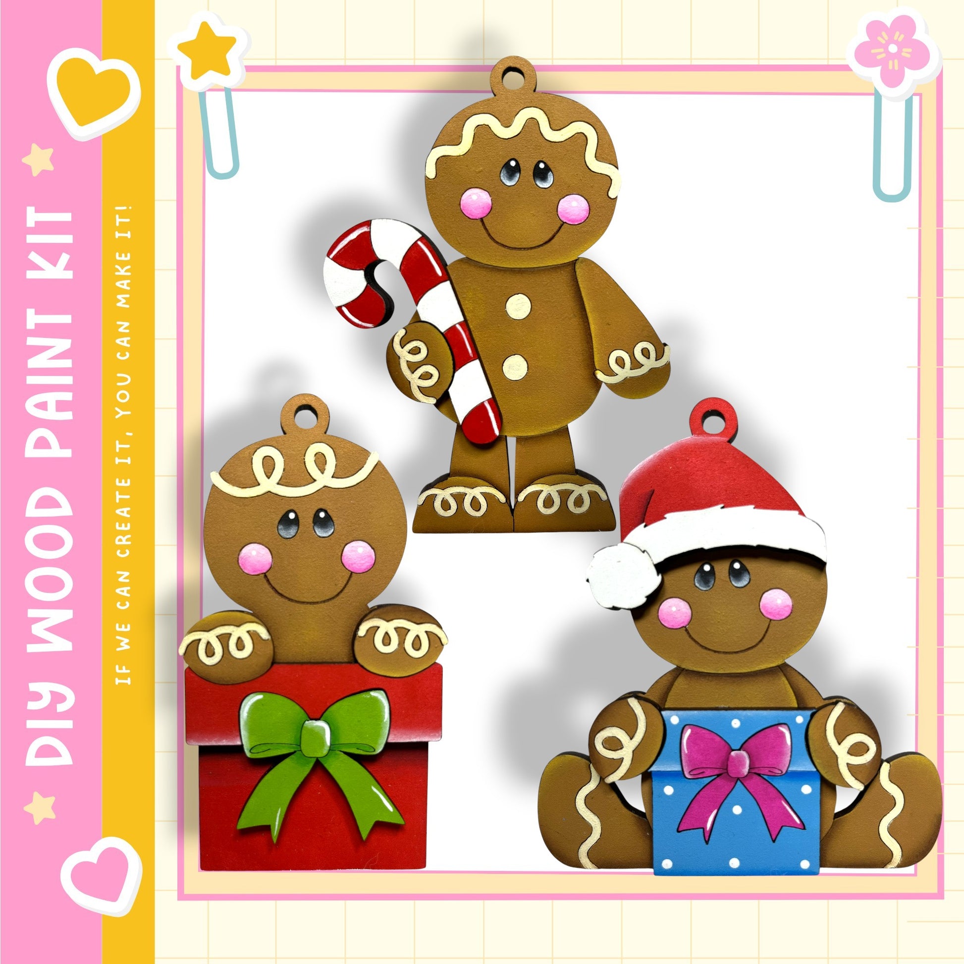 three wooden gingerbread man ornaments, each with a unique design and color. The ornaments are displayed against a pink and yellow background, creating a festive and cheerful atmosphere.