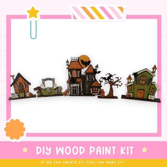 The image is a DIY wood paint kit for creating Halloween-themed houses, featuring various spooky and festive elements such as bats, skulls, and pumpkins.