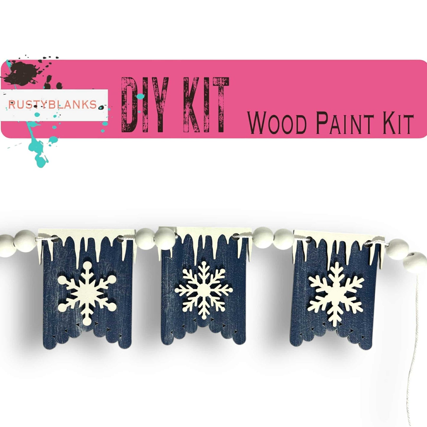 a snowflaked wooden paint kit hanging from a clothes line