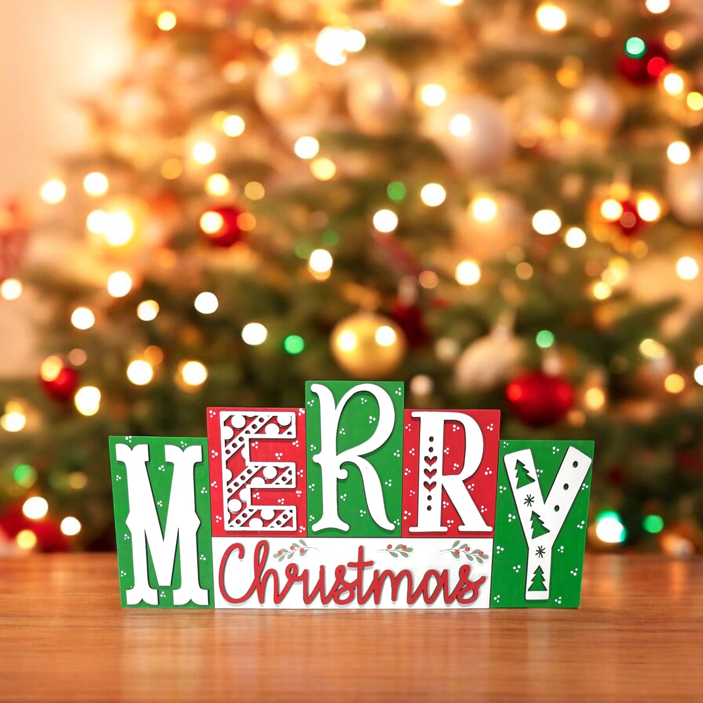 a wooden block that says merry christmas in front of a christmas tree