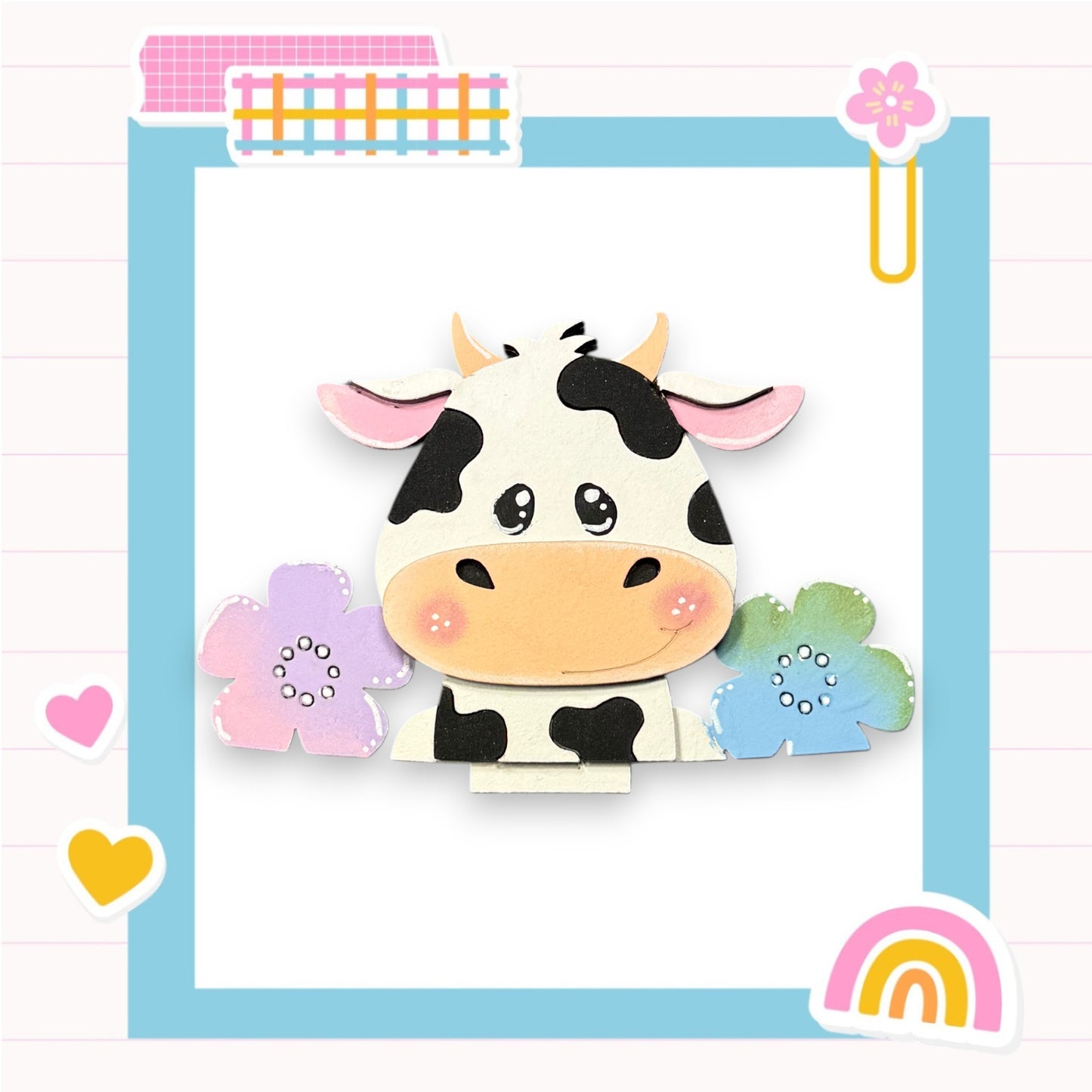 A black and white cow with pink ears and nose is surrounded by colorful flowers and a rainbow-colored object, all set against a light blue background with a pink and white checkered pattern.