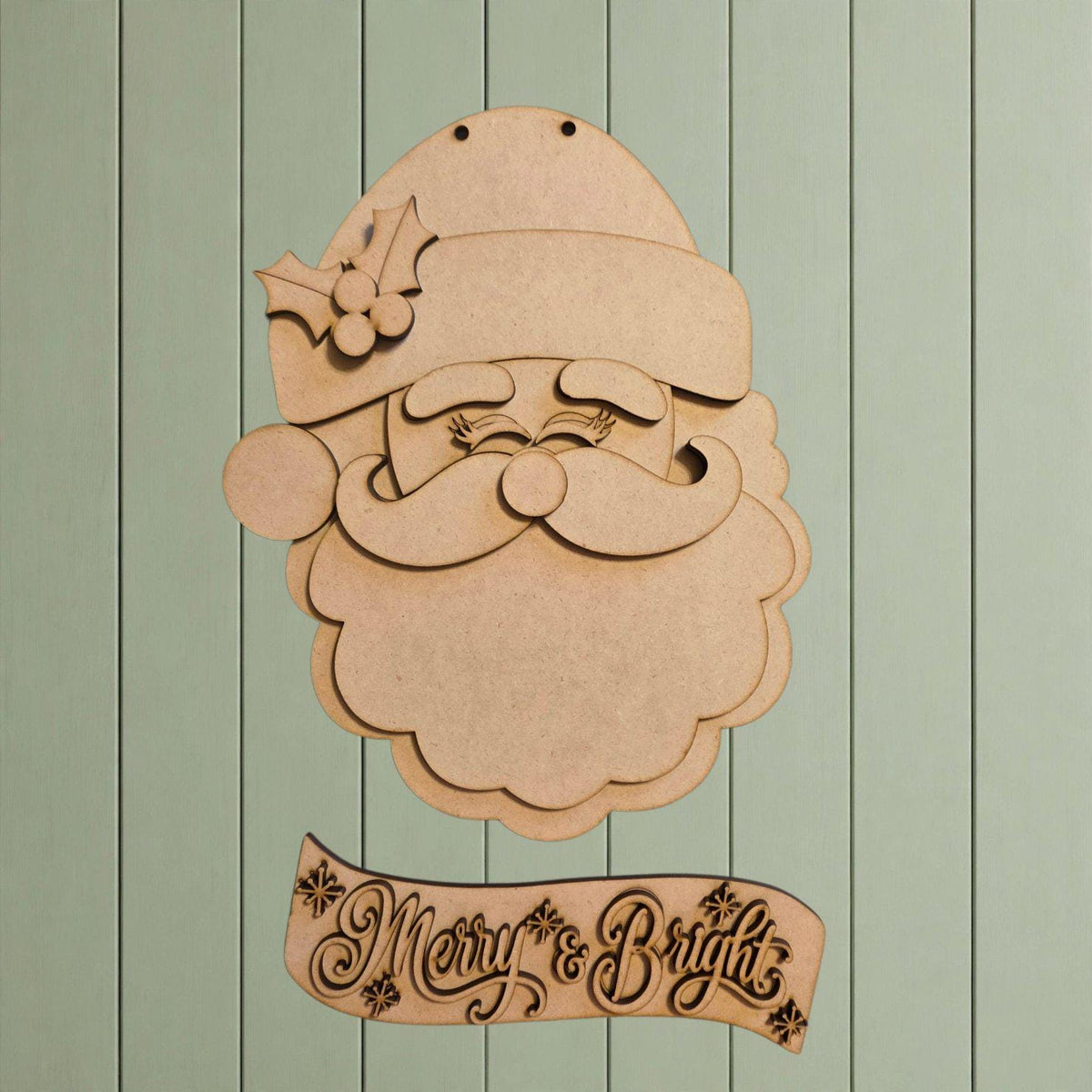 A wooden cutout of Santa Claus with a holly leaf on his hat, accompanied by a banner that says "Merry & Bright".