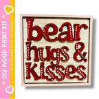 a wooden sign with the words "bear hugs & kisses" written in red letters.