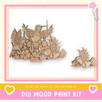a DIY wood paint kit, with a large wooden bird sculpture and smaller wooden birds displayed in a frame.