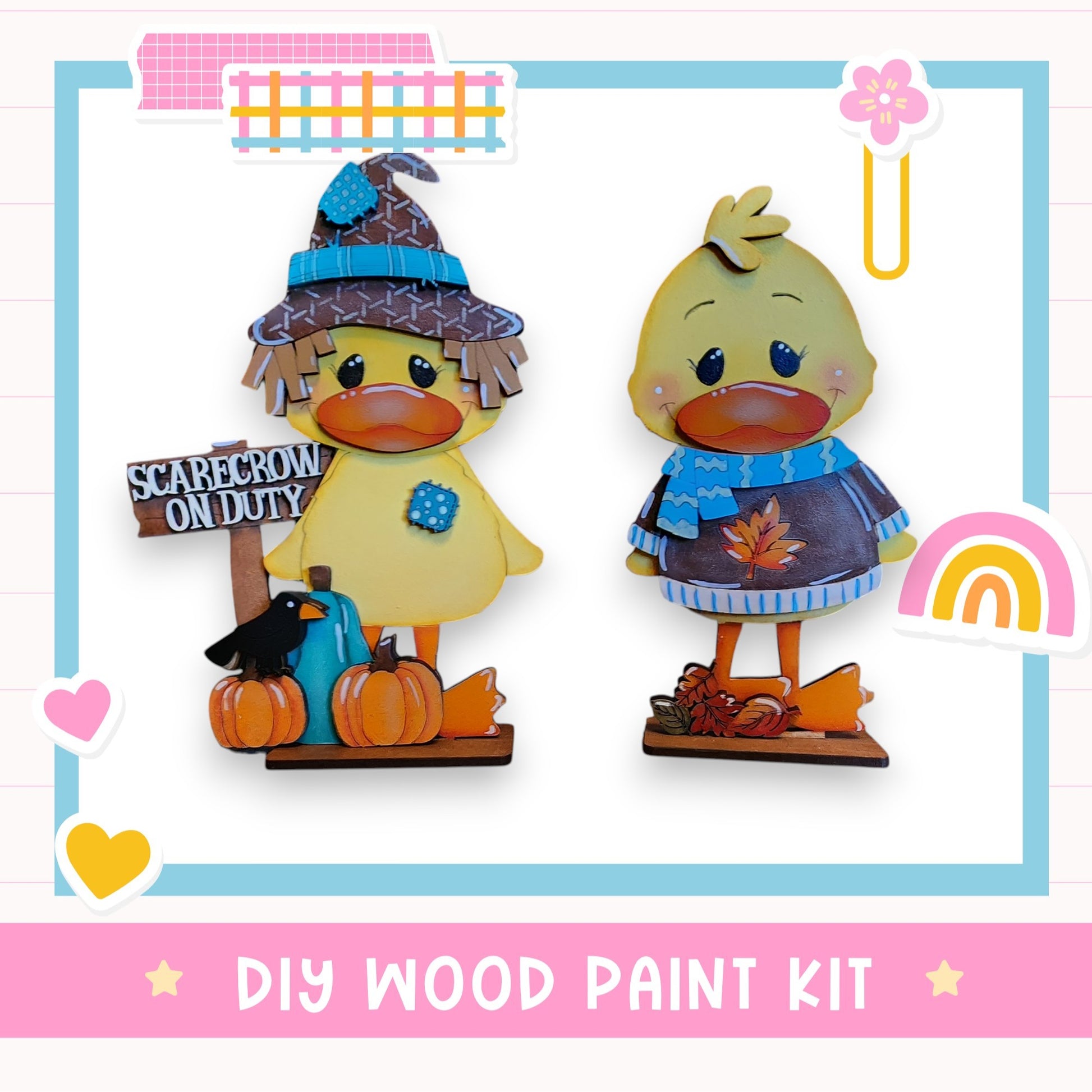 two wooden duck figurines, one wearing a witch's hat and the other a scarf, standing on a wooden base. The image also includes a sign that says "SCAREcrow ON DUTY" and a rainbow-colored flower. The text "DIY WOOD PAINT KIT" is displayed at the bottom of the image.