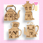 a wooden cutout of a teapot and a teapot shaped like a house