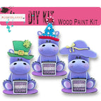 three purple hippos with a green hat on their heads