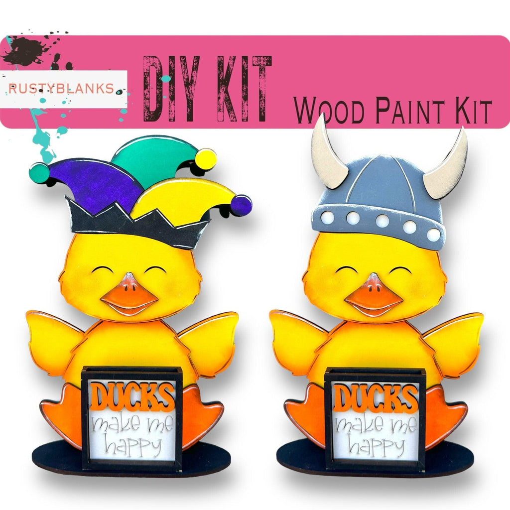 a pair of ducks wearing crowns and holding a sign