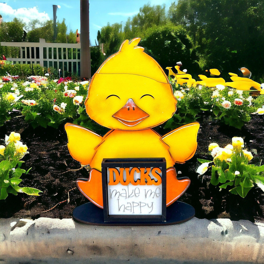 a yellow duck is holding a sign that says ducks mean happy birthday
