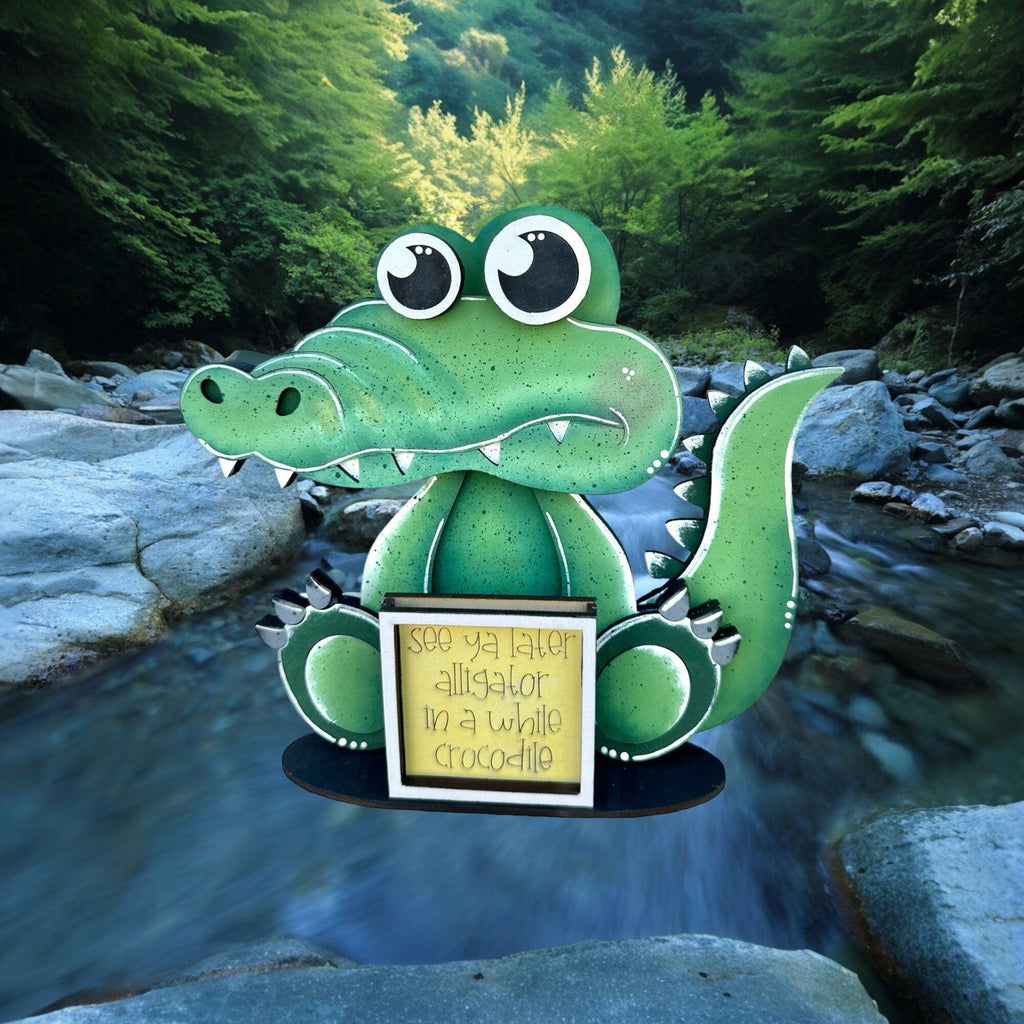 a paper cut out of a green dragon holding a sign