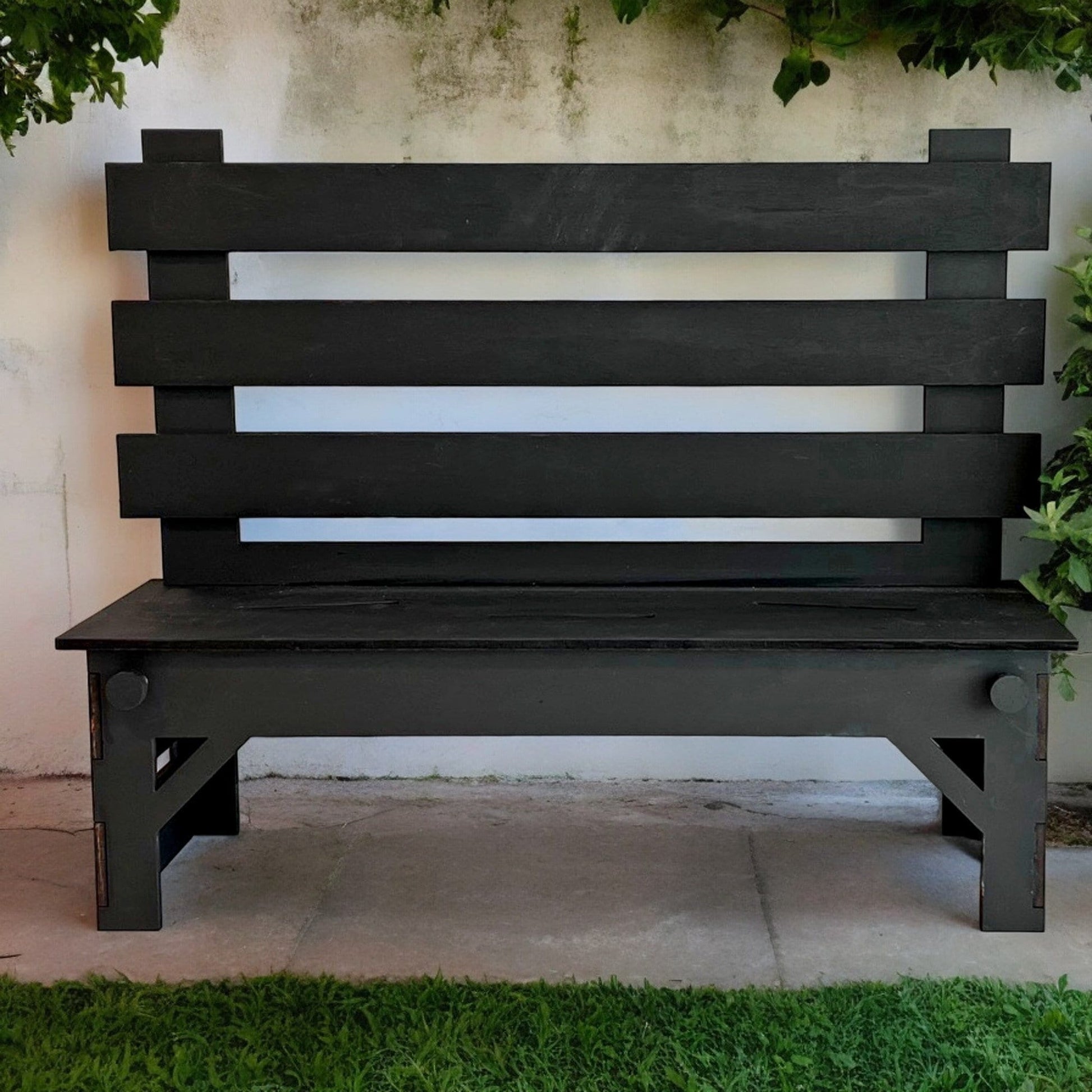 a black bench sitting in front of a building