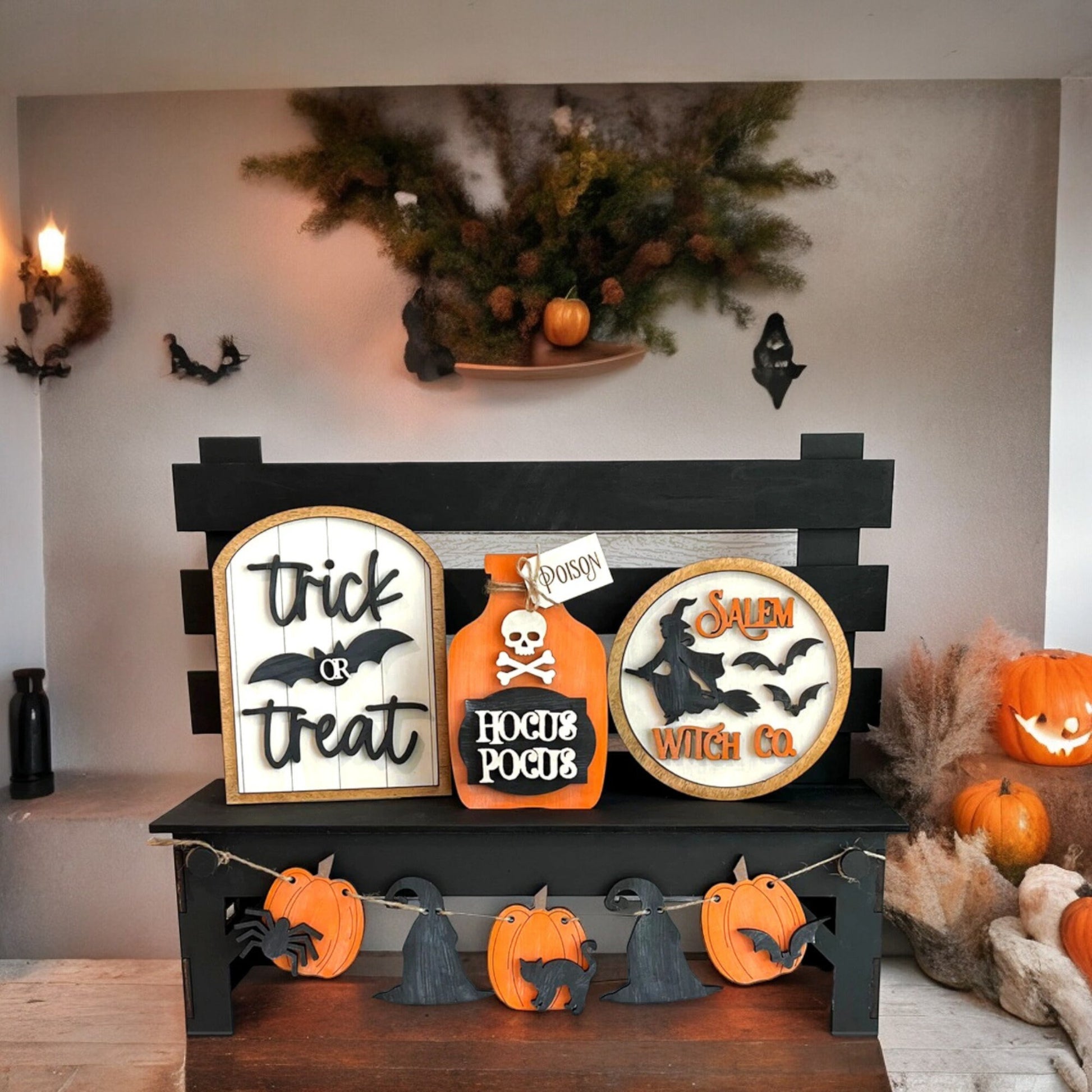 a display of halloween decorations on a mantle