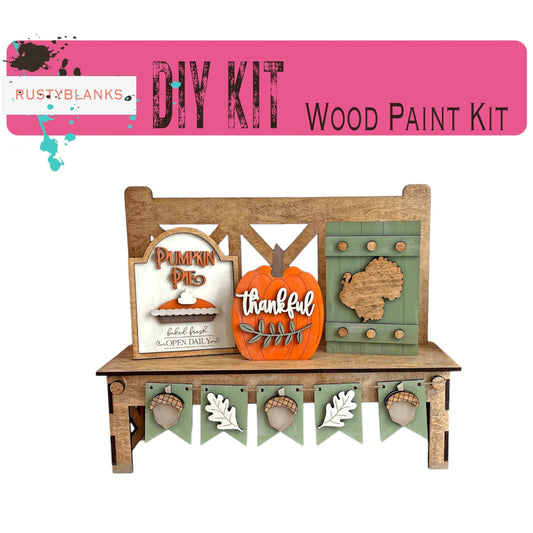 a wooden paint kit with a pumpkin on top of it
