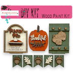 a group of wooden cutouts of pumpkins and a sign