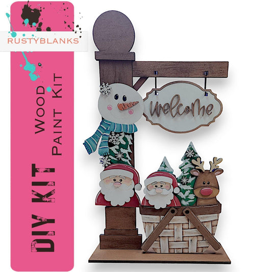 a wooden sign with a snowman and santa clause on it