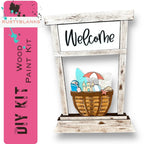 a welcome sign with a basket of items in it