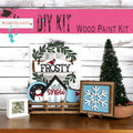 a wooden table topped with pictures and a christmas tree