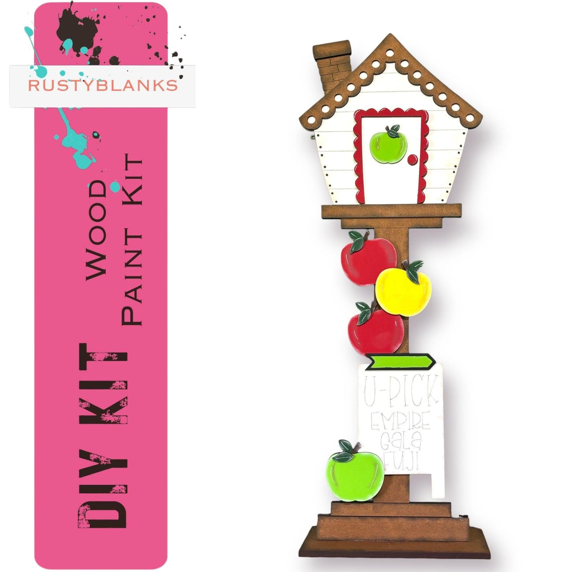 a paper model of a birdhouse with apples and an apple