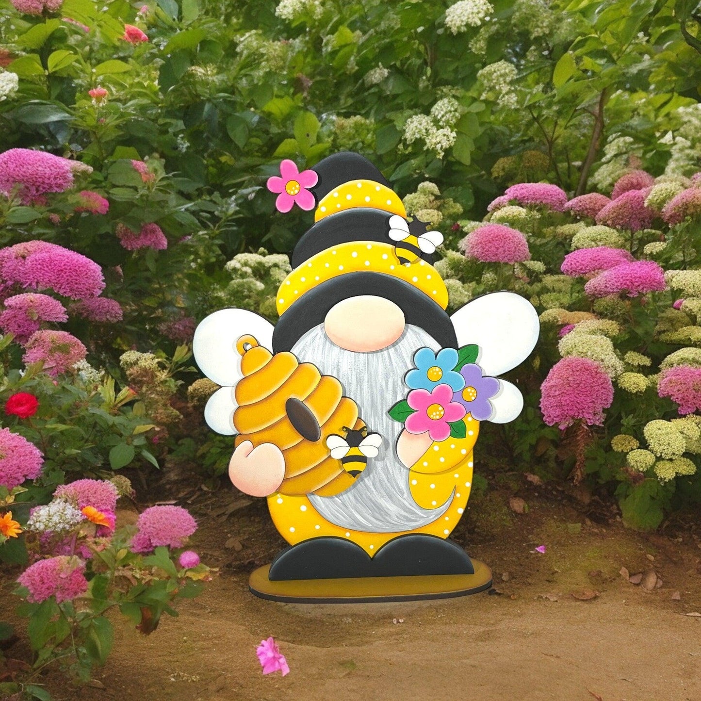 a statue of a bee holding a flower in a garden