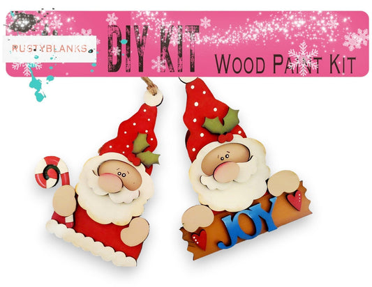 a pair of wooden santa claus ornaments hanging from a string