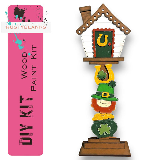 a wooden cuckoo clock with a st patrick's hat on it