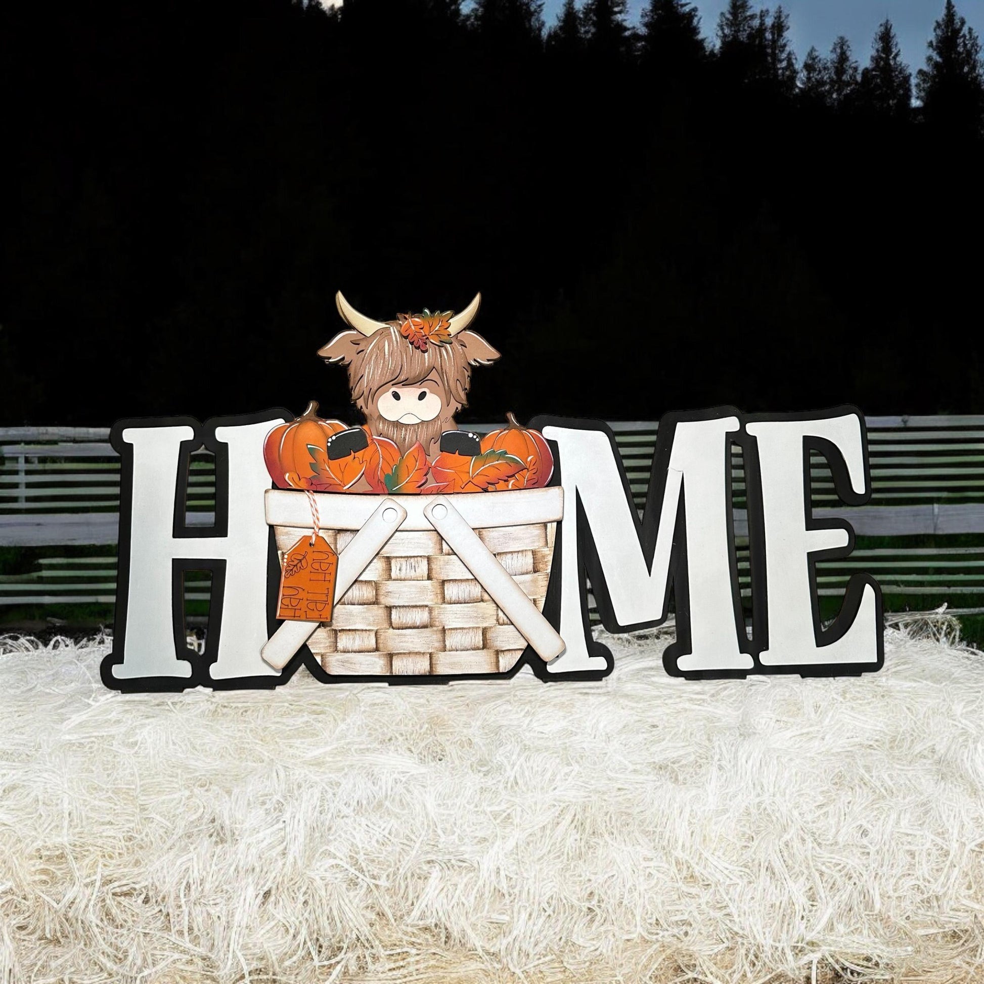 a sign that says home with a stuffed animal in a basket