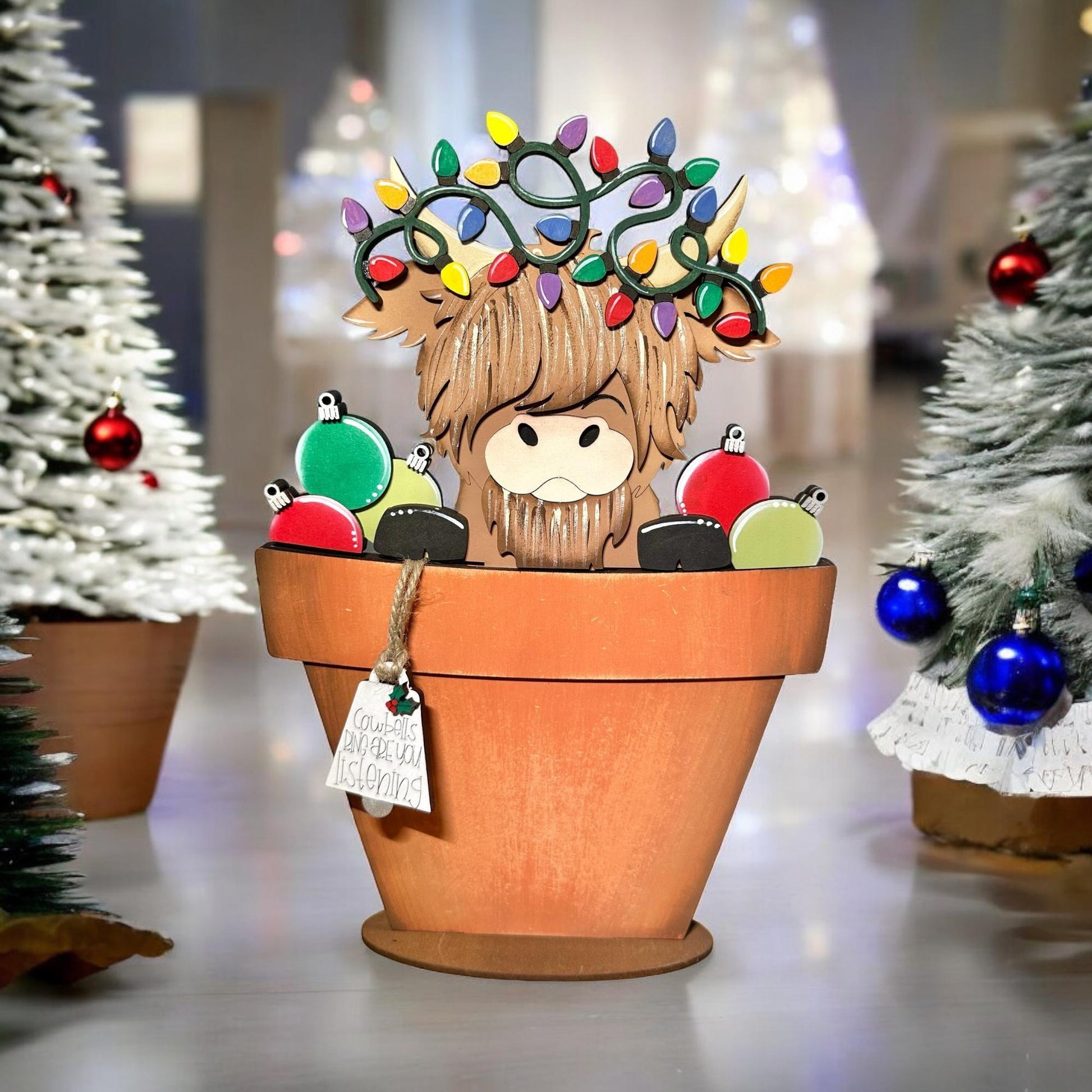 a potted plant with a christmas decoration on top of it