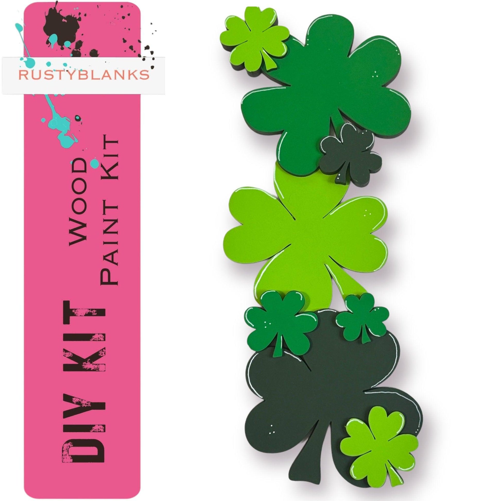 a pair of green shamrocks sitting on top of a pink bookmark