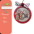 a pink and green christmas ornament with a pink bow