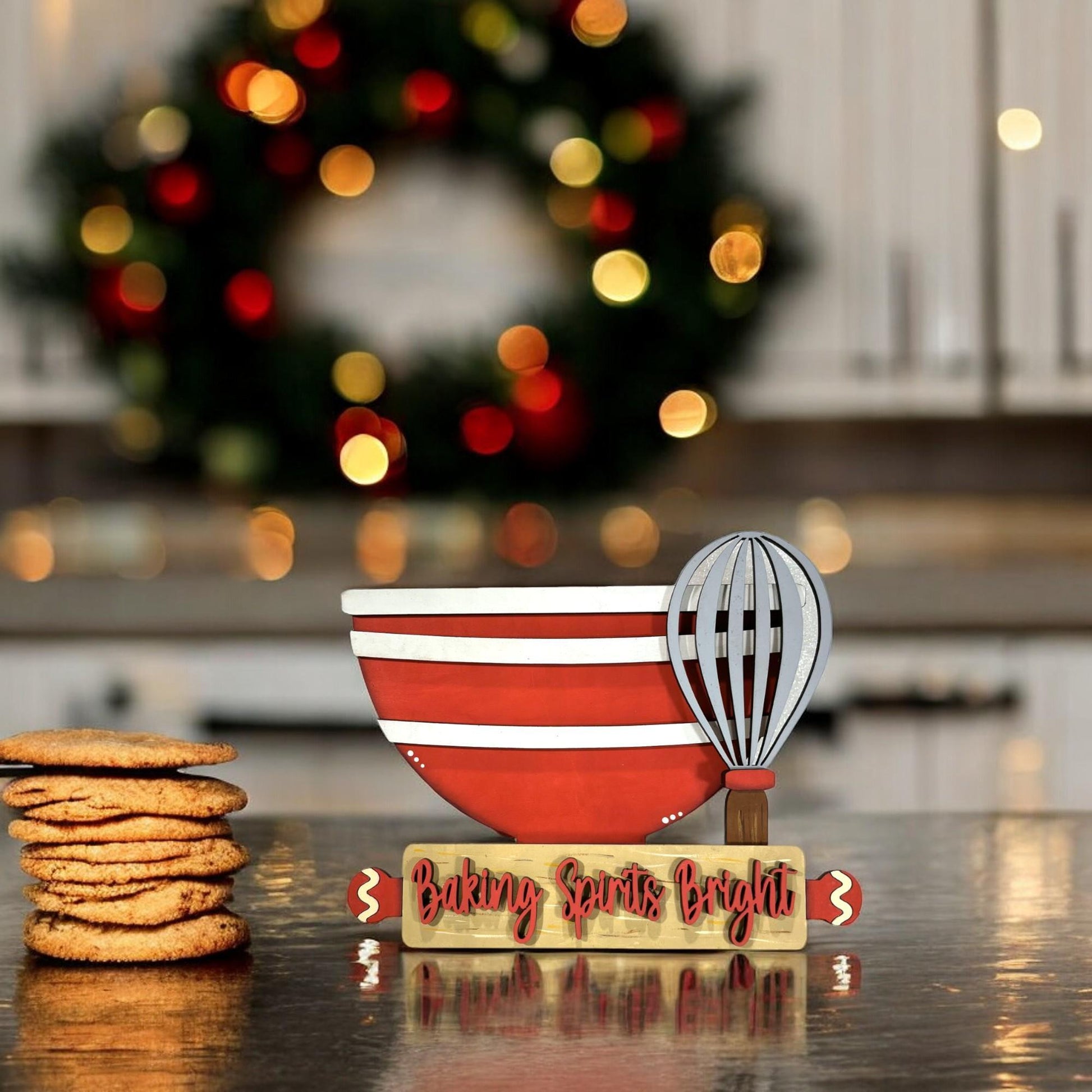 a plate of cookies and a whisk on a table