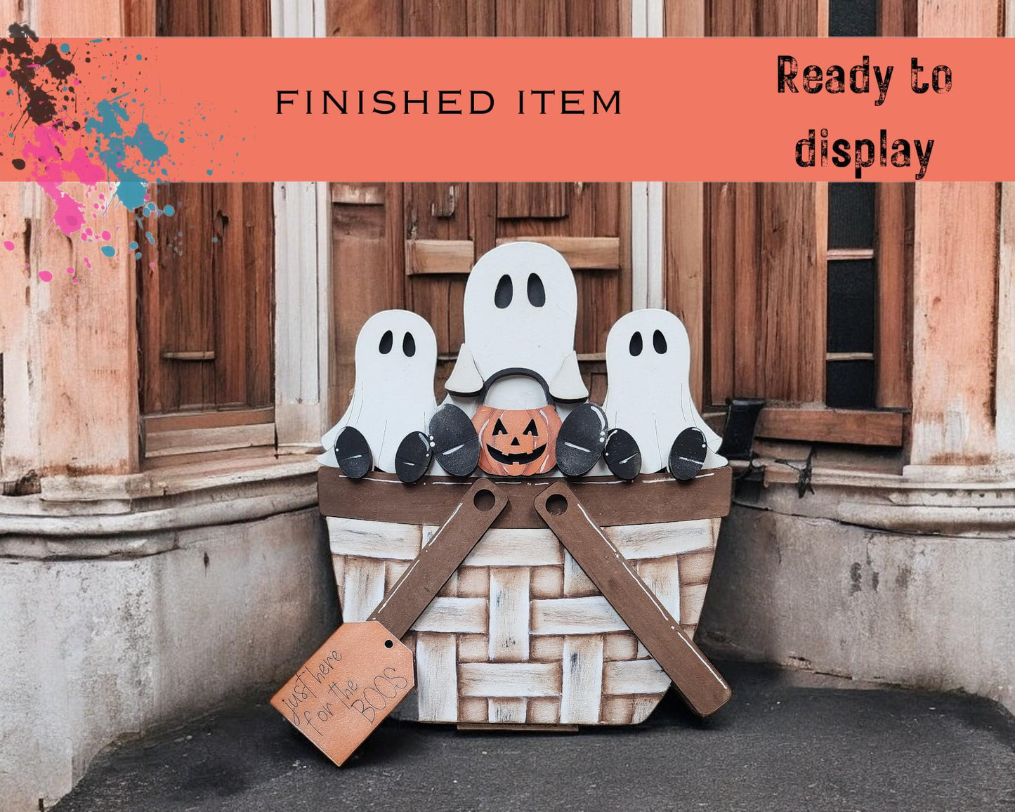 a basket filled with fake ghost heads sitting in front of a building