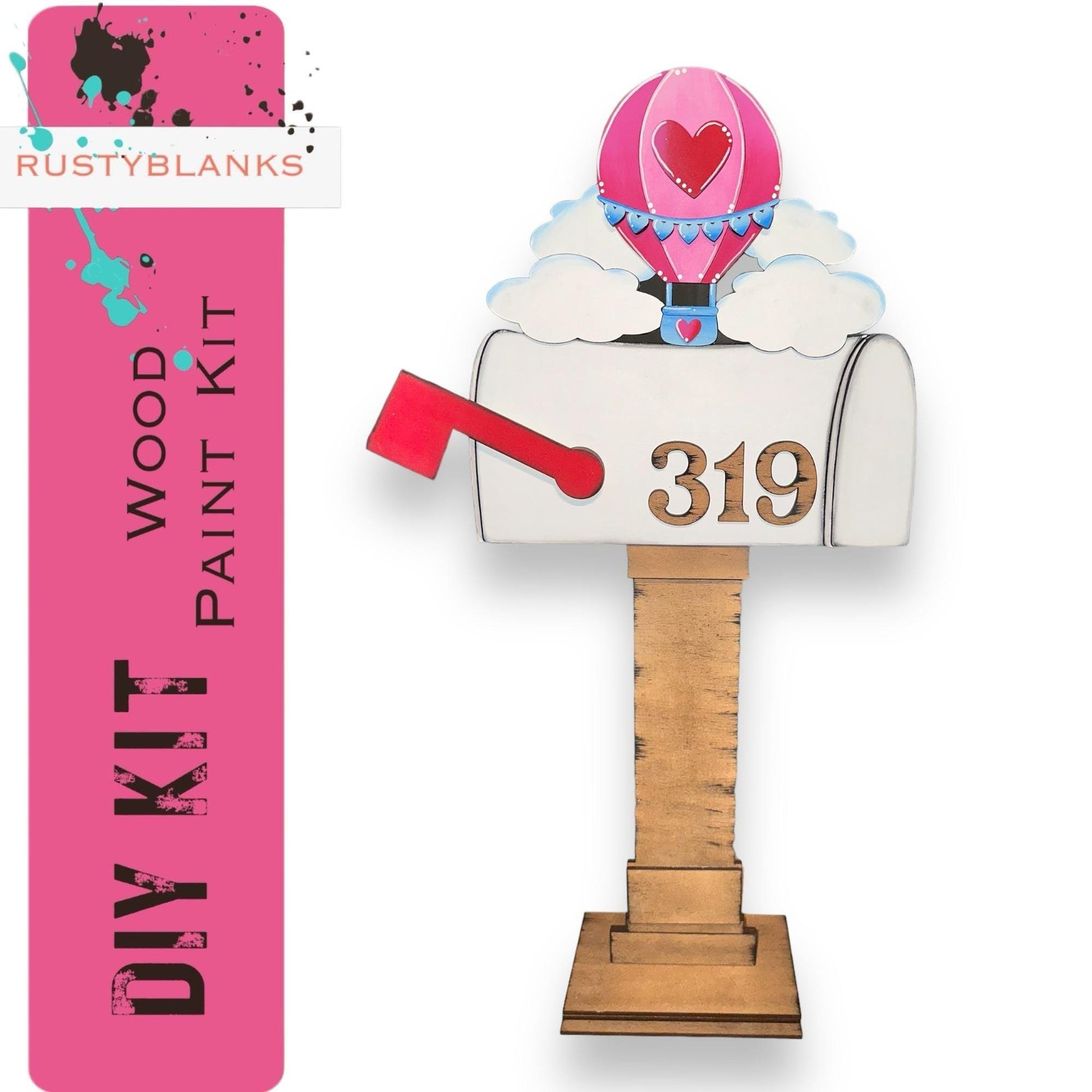 a pink and white mailbox with a heart on it