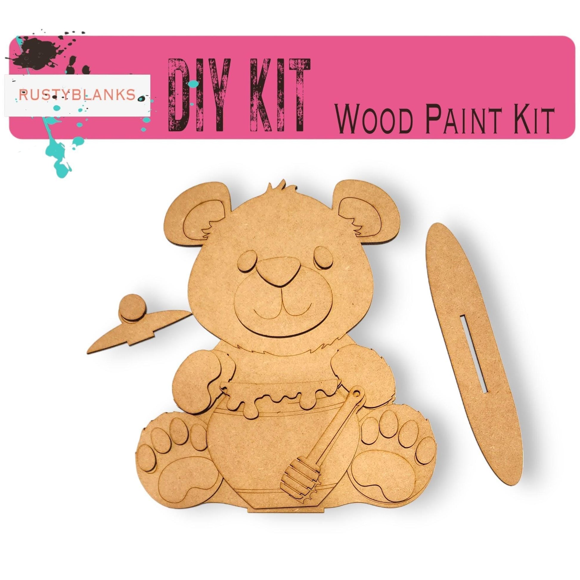 a wooden cutout of a teddy bear with scissors