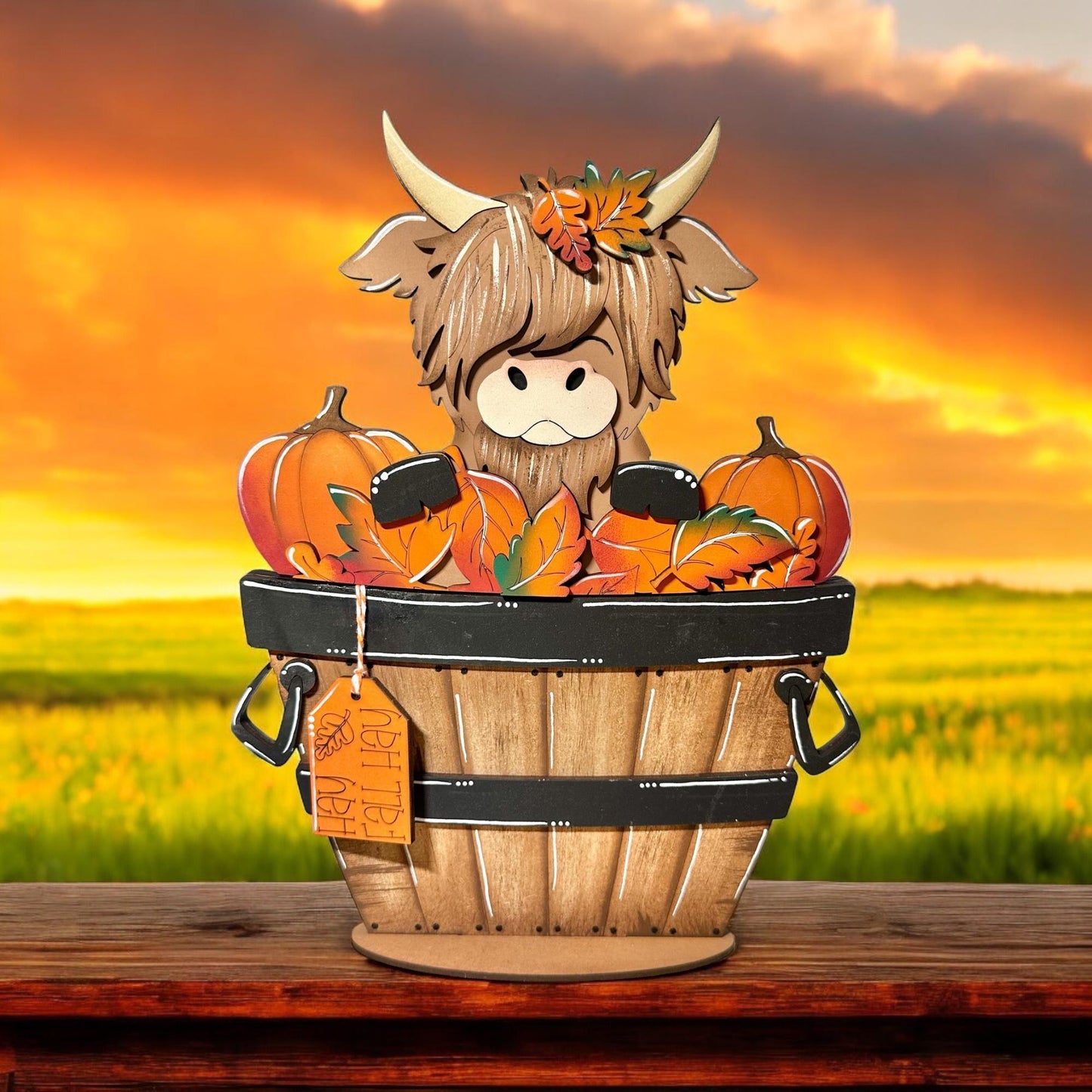 a wooden basket filled with pumpkins on top of a wooden table