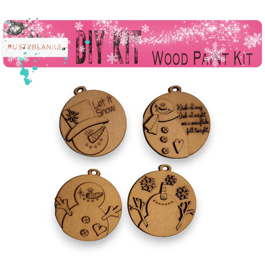 a set of four wooden charms with a picture of a snowman