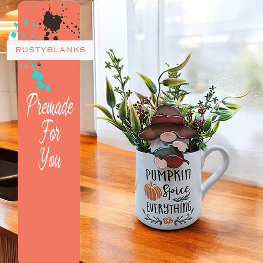 a mug with a plant in it sitting on a counter