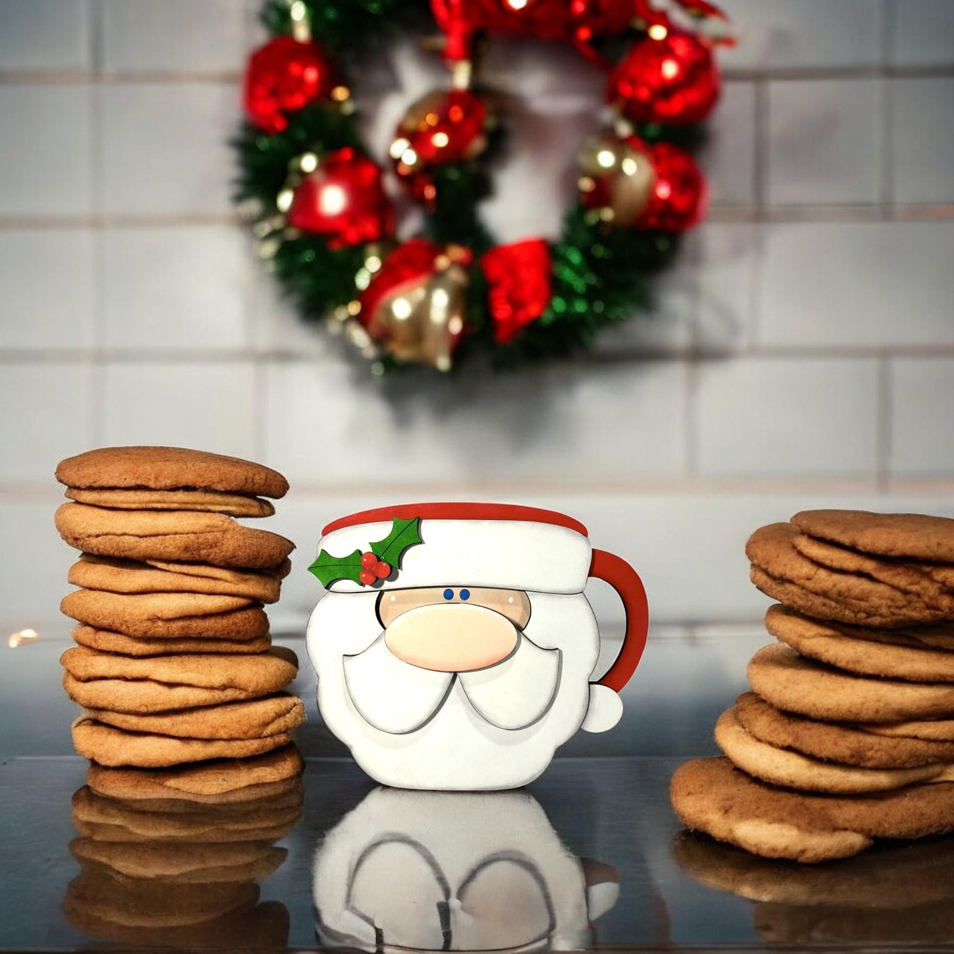 a stack of cookies next to a santa clause mug