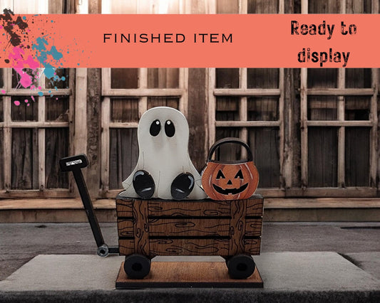 a wooden crate with two pumpkins and a jack - o - lantern in it