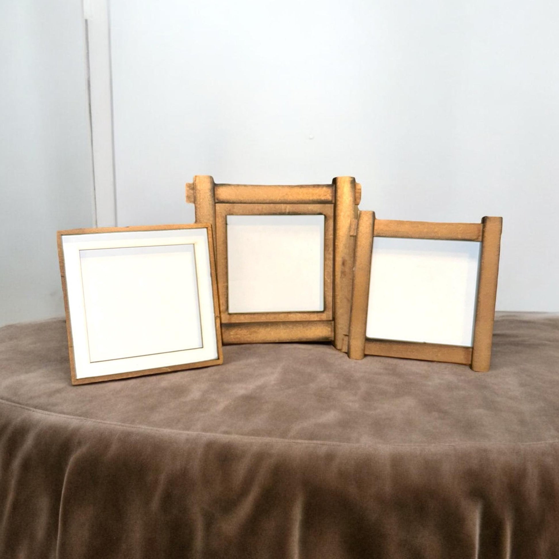 three wooden frames sitting on top of a table