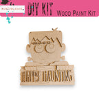a wooden carving of a cartoon character holding a sign