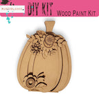 a wooden cutout of a pumpkin with flowers