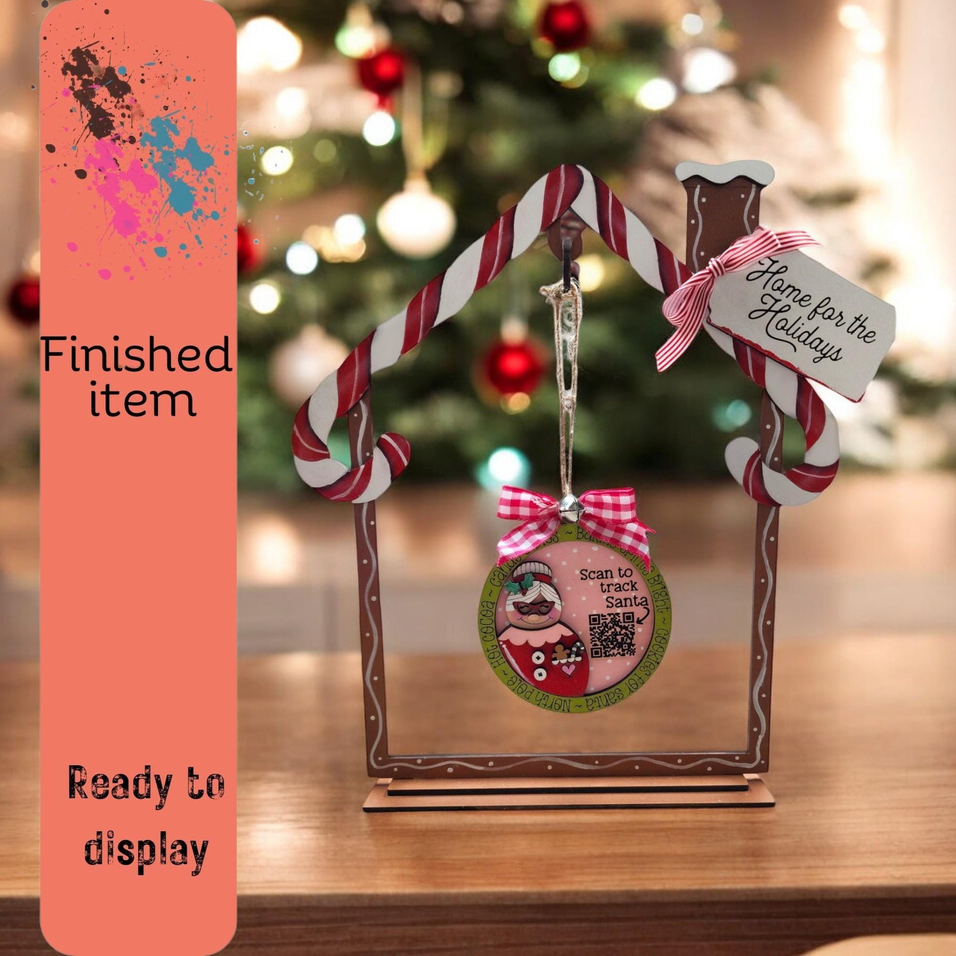 a picture frame with a christmas ornament hanging from it