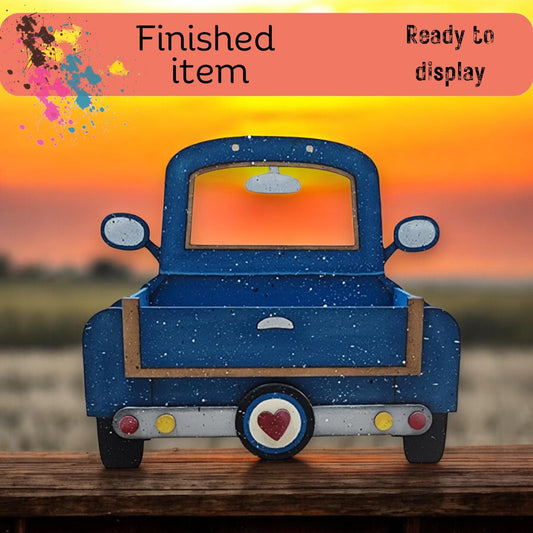 a blue toy truck sitting on top of a wooden table