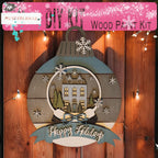 a wooden christmas ornament hanging on a wooden fence