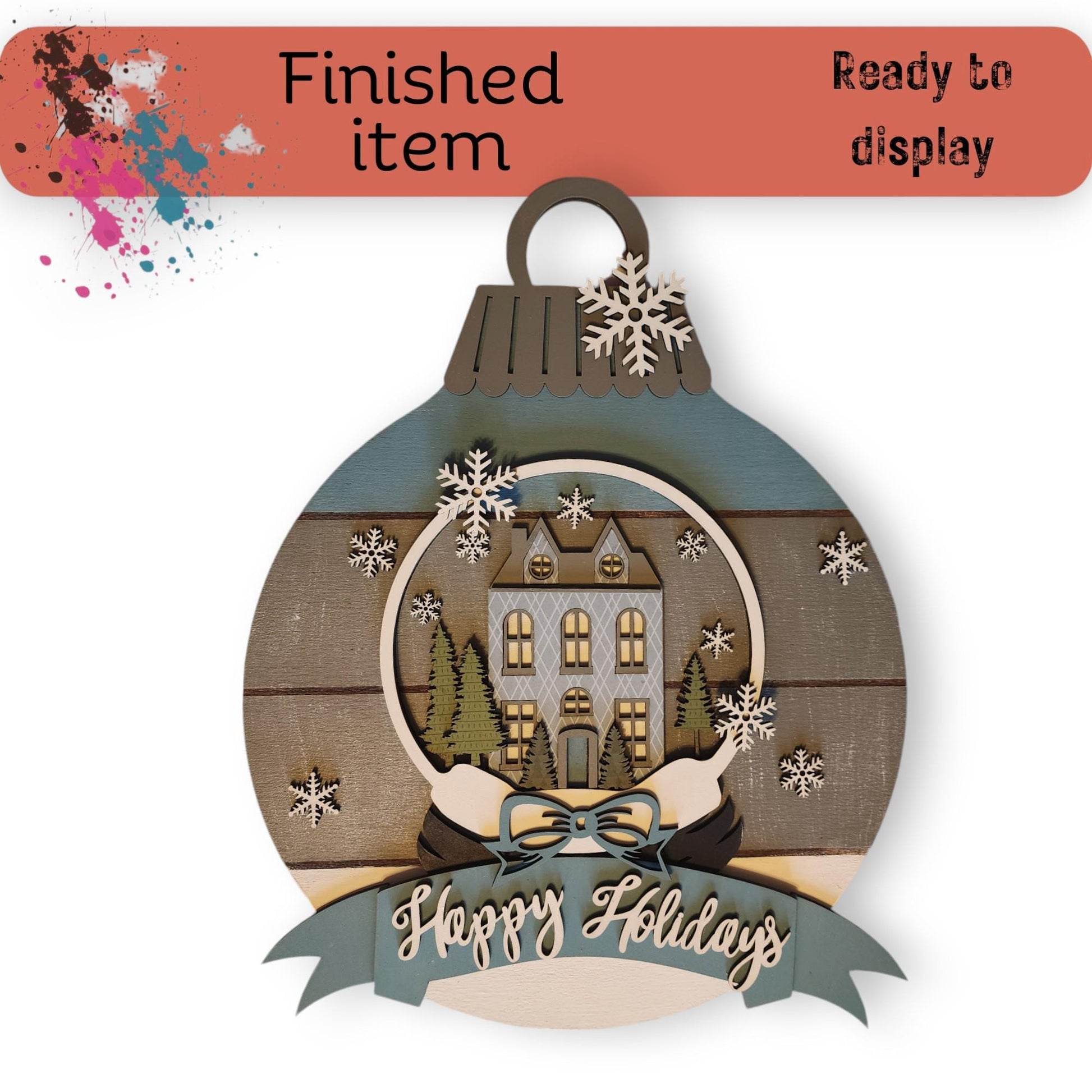 a christmas ornament with a house on it