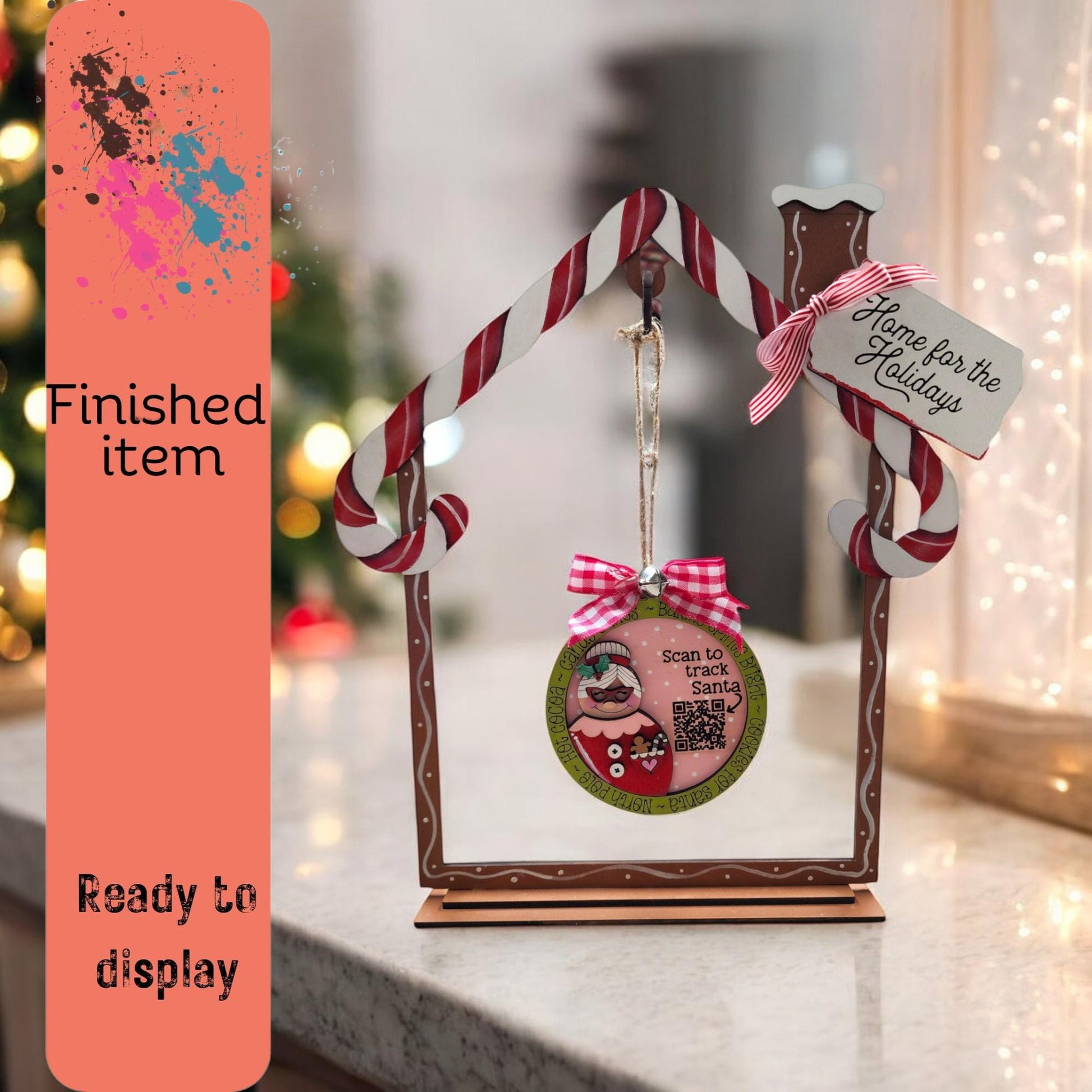 a picture frame with a christmas ornament hanging from it