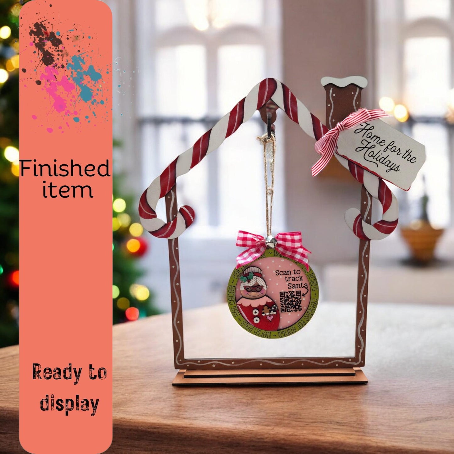 a picture frame with a christmas ornament hanging from it