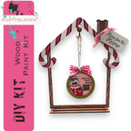a birdhouse ornament with a pink ribbon around it